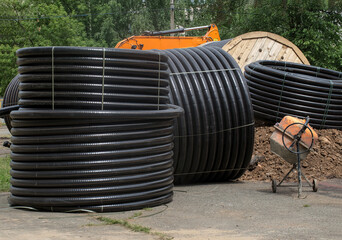 Several coils of black polyethylene pipes for gas supply