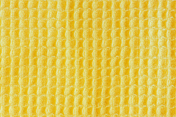 Waffle kitchen towel texture. Illuminated yellow background or wallpaper.