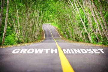 Growth mindset written on asphalt road surface. Self development to success concept and challenge keep moving idea - obrazy, fototapety, plakaty