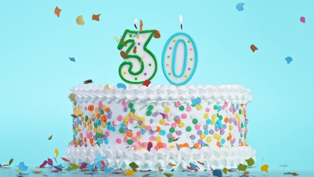 Birthday Cake With Burning Colorful Candles with Number 30 on Pastel Background. Falling confetti. Super Slow Motion, 1000 FPS.