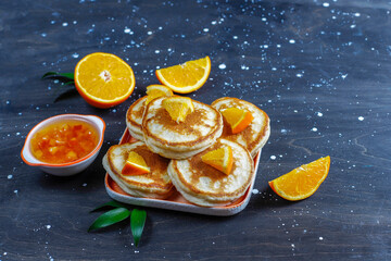 Homemade american pancakes with orange fruits.