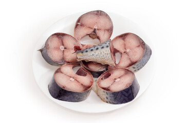 Slices of uncooked thawed chub mackerel on a white dish