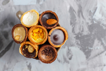 Mini waffle cones filled with chocolate and nuts.