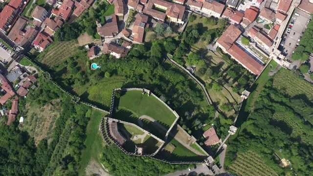 Soave castle aerial view, province of Verona, Italy. Aerial panorama of Italy castles. Spiral flight down. The famous medieval castle on the hill. Italian historic castles.