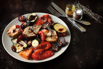 Baked vegetables and fruits on a platter. Macro.