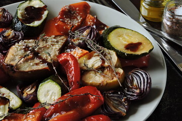 Baked vegetables and fruits on a platter. Macro.