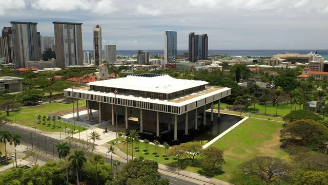 Cinematic 4K orbiting drone footage of the Hawaii State Capitol and downtown Honolulu, a Polynesian, Pacific Island tourist destination on Oahu island in Hawaii known for its surfing and beaches