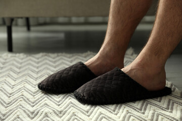 Man in soft slippers at home, closeup