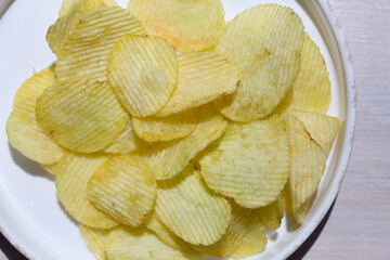 Close-up of potato ribbed chips. Chips background