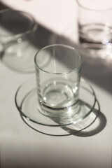 lifestyle empty glasses and plates on a light table