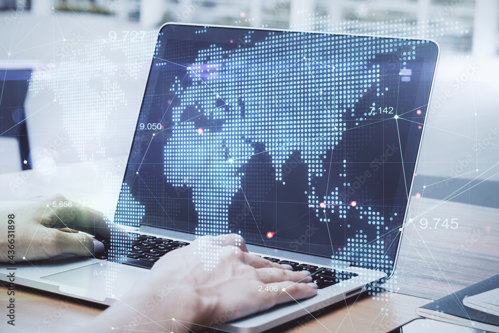 Poster global business and information concept. side view and close up of hands at desktop using laptop wit