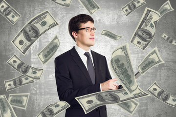 Leadership and winner concept with businessman surrounded by us dollars bills on abstract background.
