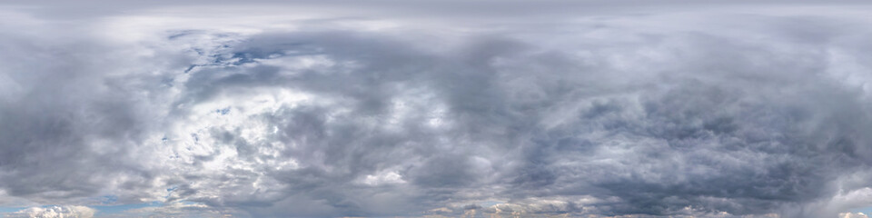 Obraz premium blue sky with beautiful dark clouds before storm. Seamless hdri panorama 360 degrees angle view with zenith for use in 3d graphics or game development as sky dome or edit drone shot