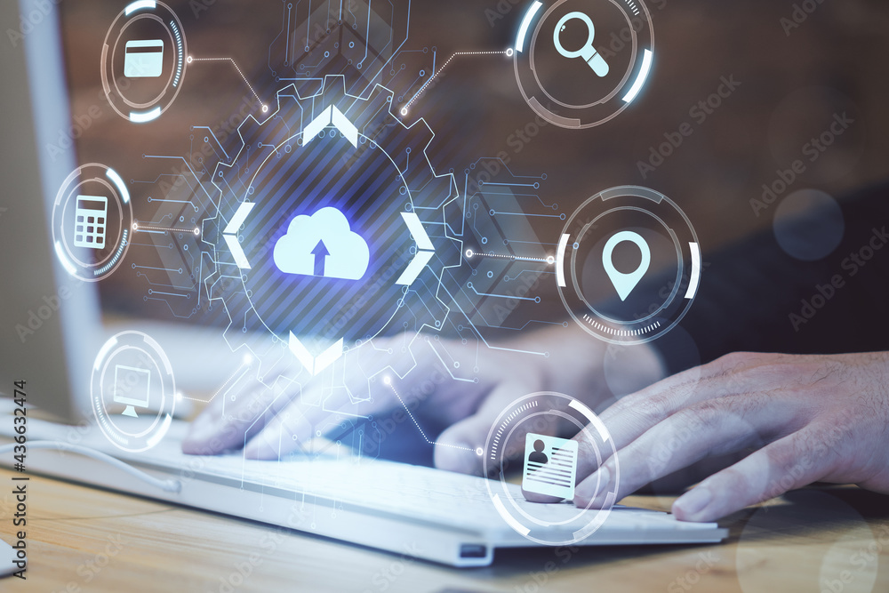 Aufkleber Cloud computing concept with virtual cloud icon surrounded by card, magnifier, navigation mark and computer symbols on man hands on keyboard background.