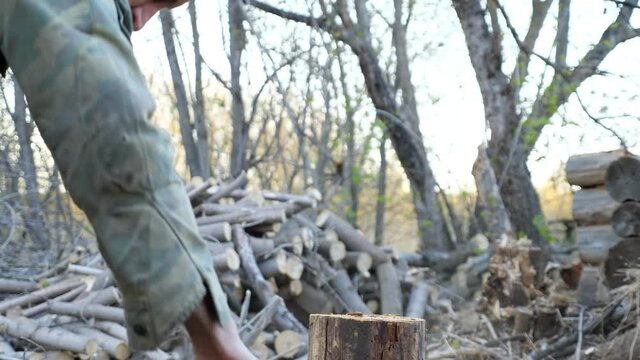 man chopping wood with an ax.