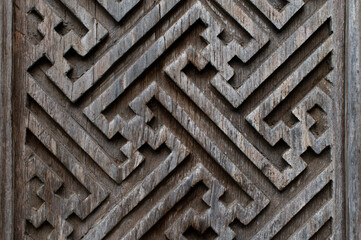 Balinese wood carving background. Graphic angular patterns on the doors.