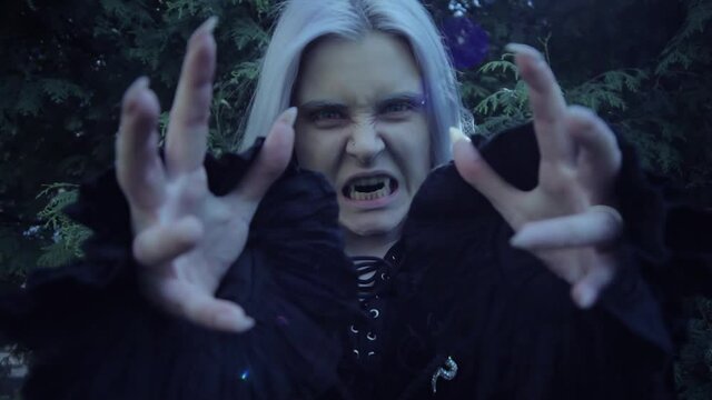 Angry vampire woman shows teeth. She's awful.