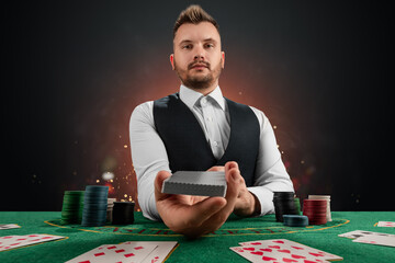 Male dealer at the casino at the table. Casino concept, gambling, poker, chips on the green casino table. - obrazy, fototapety, plakaty