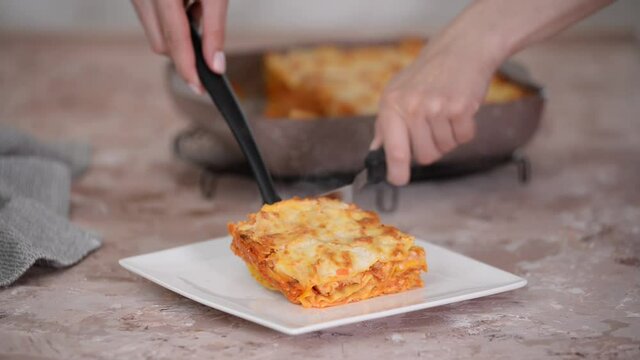 Tasty traditional italian lasagna. Piece of Lasagne on white plate.