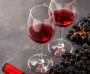 Fotobehang Red wine in glasses on the table © hannamartysheva