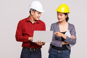 Engineers with blueprint and tablet in studio