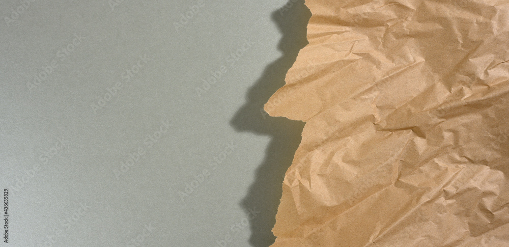 Poster mint brown piece of paper with torn edges and shadow on gray background. abstract creative backdrop 