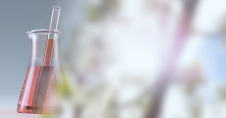 Composition of red liquid and stirrer in flask, with blurred pink blossom copy space to right