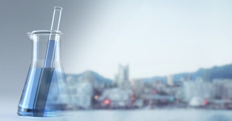 Composition of blue liquid and stirrer in chemistry flask, with blurred copy space to right