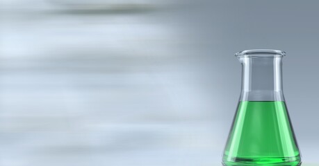 Composition of conical flask of green liquid, with blurred copy space