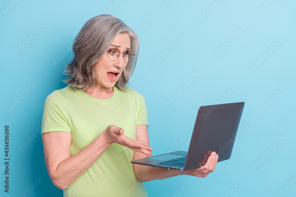 Sticker Photo of shocked angry unhappy old woman look laptop deadline isolated on pastel blue color background