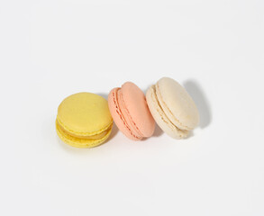 round multicolored macarons on a white background with a shadow