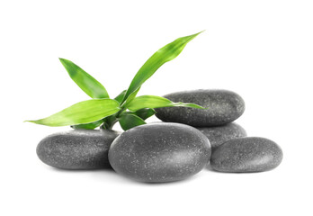 Spa stones and bamboo sprout on white background