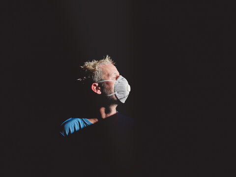 Man in respirator near window