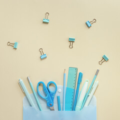 Back to school creative concept. Open envelope and school supplies