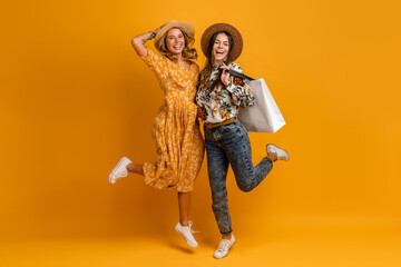 two beautiful attractive stylish women friends having fun together jumping