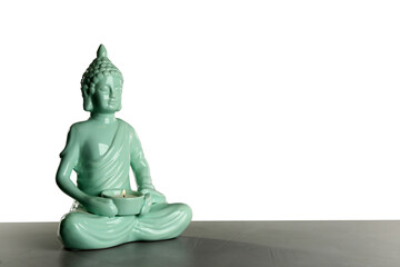 Beautiful ceramic Buddha sculpture with burning candle on table against grey background. Space for text