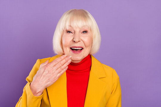 Photo of impressed pretty short hairdo elder lady hand mouth wear yellow jacket isolated on purple color background