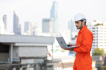 technician or engineer holding walkie talkie and laptop computer on the top of the roof