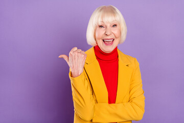 Photo of impressed cute short hairdo aged lady point empty space wear yellow jacket isolated on...