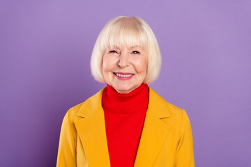 Photo of optimistic cute short hairdo senior lady wear yellow jacket isolated on purple color background
