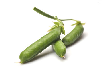 Pods of green peas with leaves isolated on white background