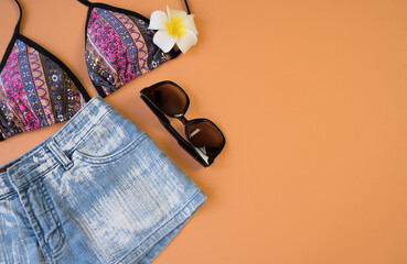 Shorts, sunglasses, swimsuit, plumeria flower, summer vacation concept. Summer entertainment...