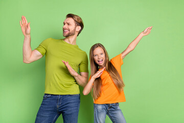 Portrait of attractive cheerful people dad daddy dancing having fun good mood isolated over green color background