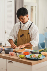 Chef takes rice for sushi rolls. Preparing ingredients for making sushi. Food delivery online service. Japanese cuisine: rolls, soy sauce, wasabi. Promo for restaurant