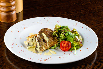 fish dorada with fresh salad in restaurant