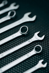 Set of chrome wrenches on steel surface. Mechanic tools for maintenance. Hardware tools to fix