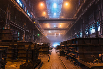 Long huge workshop or hangar in metallurgical plant, foundry manufacturing, heavy industry.