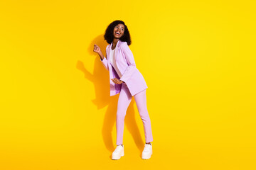 Full size photo of young happy smiling african businesswoman dancing look copyspace isolated on yellow color background