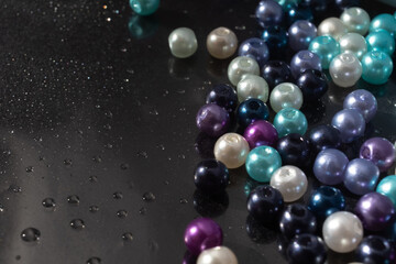 color beads on black paper