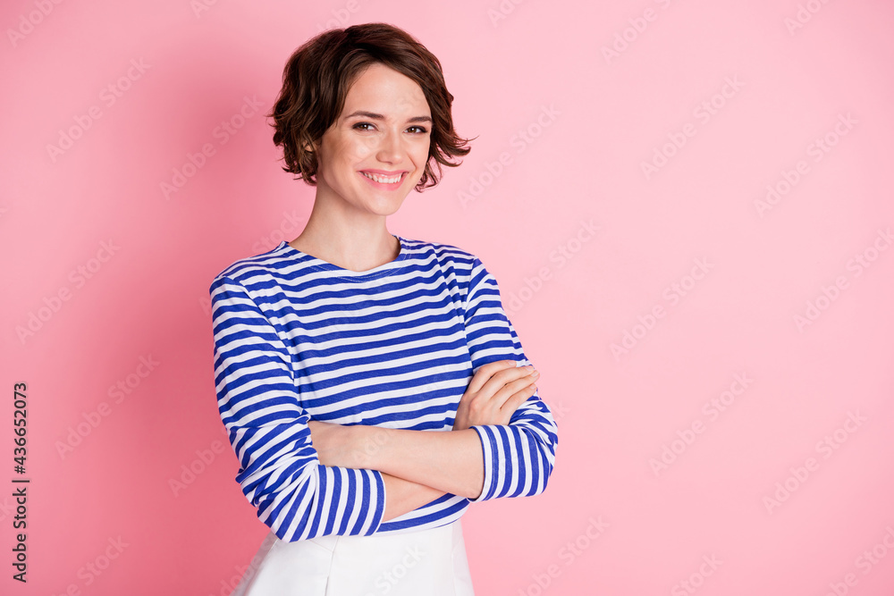 Sticker Photo of young beautiful smiling cheerful positive girl with folded arms look camera isolated on pink color background